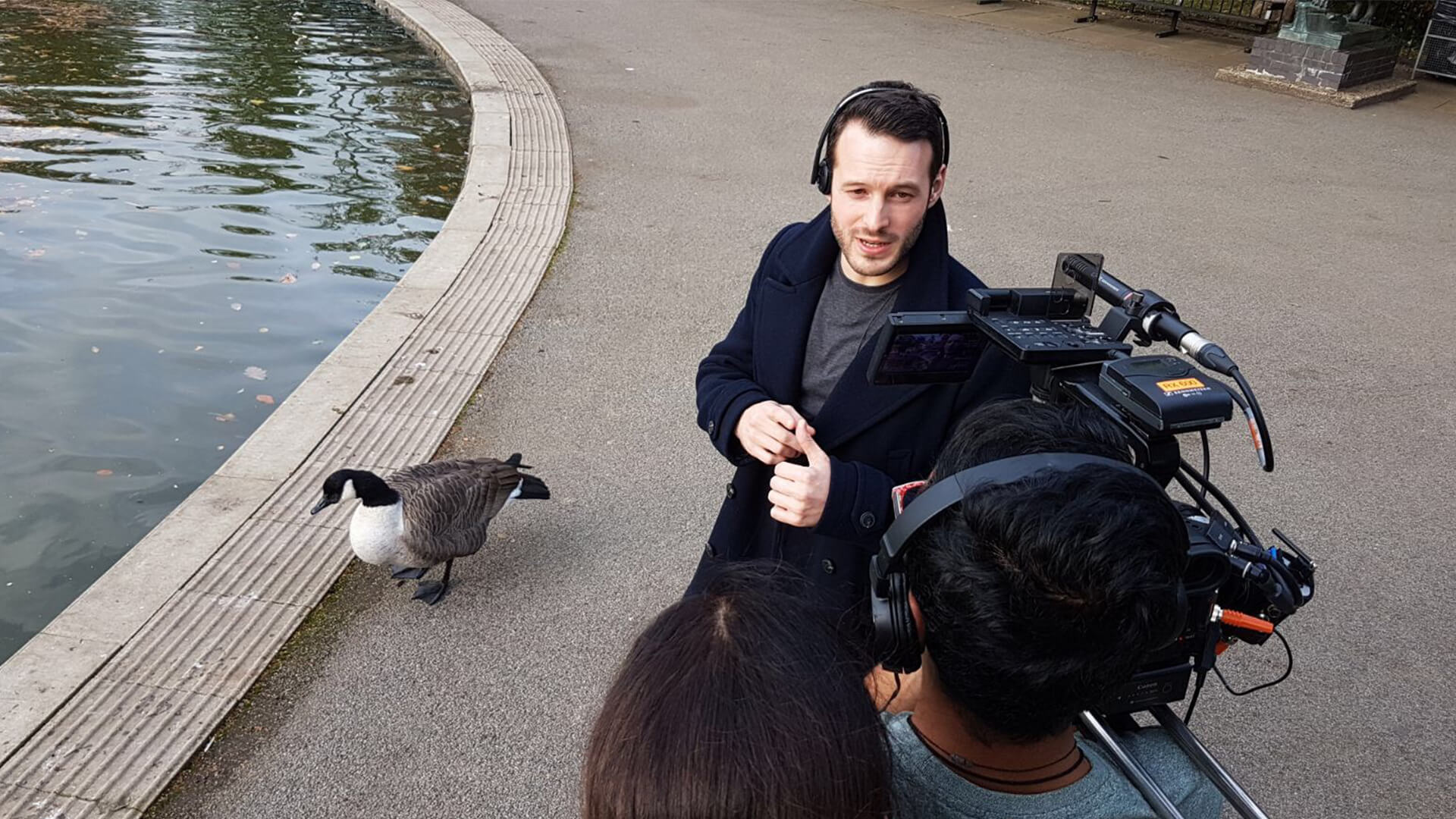 e4 presenter aaron calvert being interviewed about hypnosis project by a pond about stage entertainment