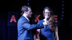 Aaron Calvert on stage with girl smiling